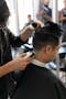 Servilles Academy barbering student does a low fade on client